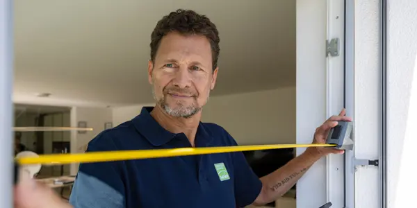 Handwerker misst grosse Tür
